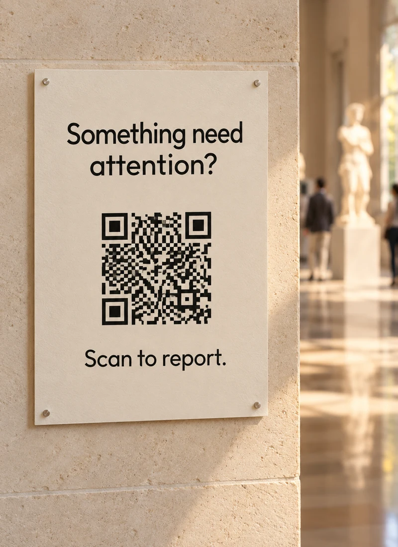 A printed museum sign reading Something need attention? Scan to report.